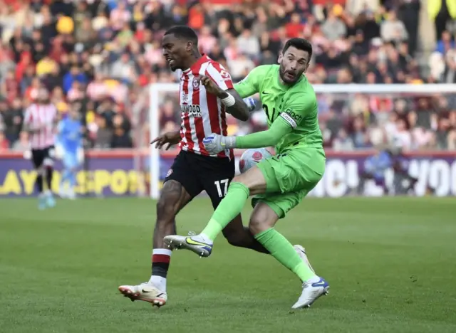 Ivan Toney is challenged by Hugo Lloris