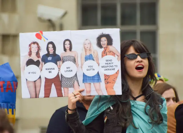 A protestor holds a placard featuring the UK pop band the Spice Girls at a protest in solidarity with Ukraine in London