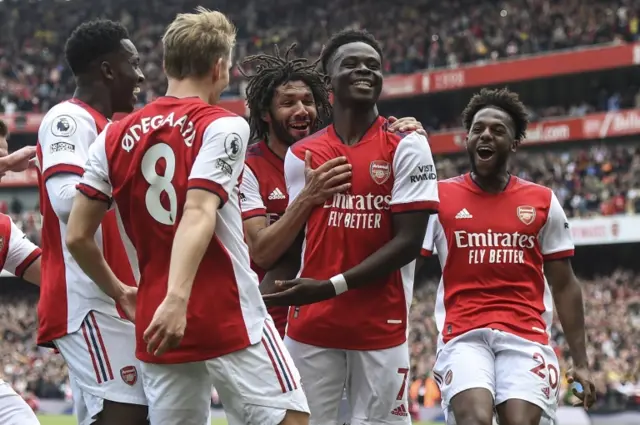 Bukayo Saka celebrates after scoring a penalty against Manchester United