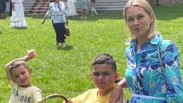 Nataliya Hevak with her youngest and eldest son in a park