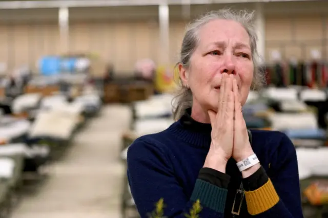 A woman cries at an Easter meal gathering in Przemysl, eastern Poland. Photo: 24 April 2022