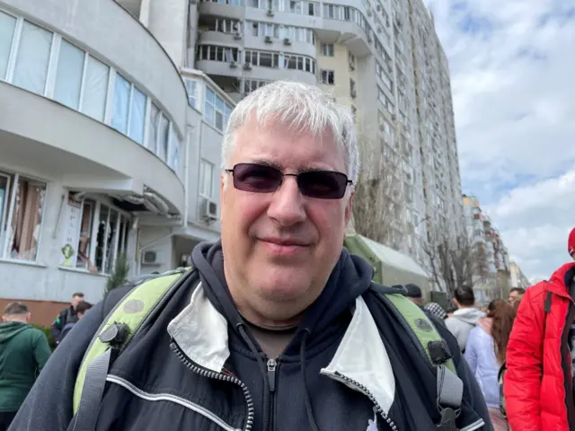 Portrait of Igor in front of a residential building in Odesa