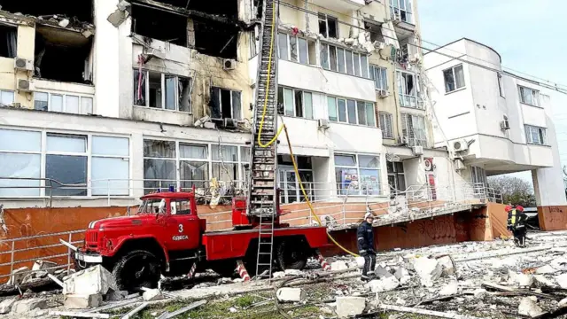 Emergency service workers rescue people in Odesa after a missile strike