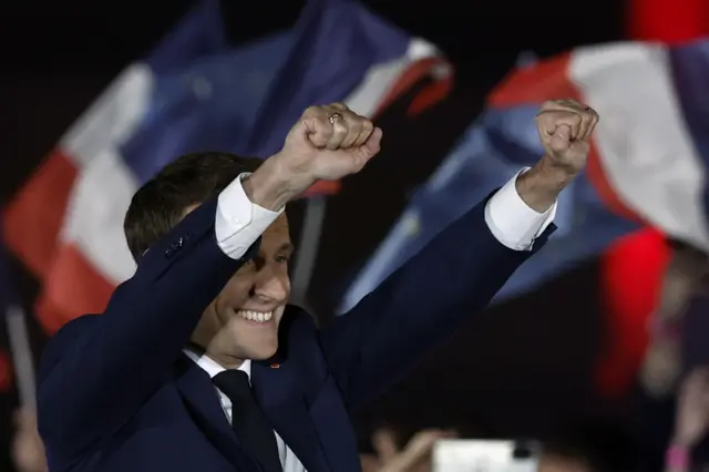 French President Emmanuel Macron gestures on stage, after being re-elected as president, following the results in the second round of the 2022 French presidential election, during his victory rally at the Champ de Mars in Paris, France, April 24, 2022.