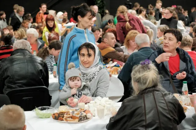 Ukrainian refugees attend a traditional Easter meal organised by aid organisations in in the Polish village of Nadarzyn, near Warsaw. Photo: 24 April 2022