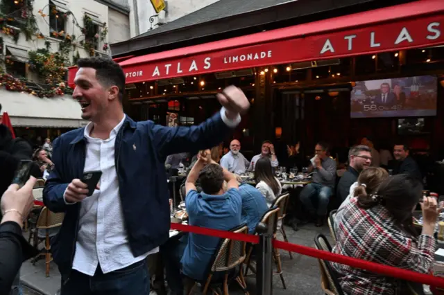 People celebrating outisde a Paris cafe