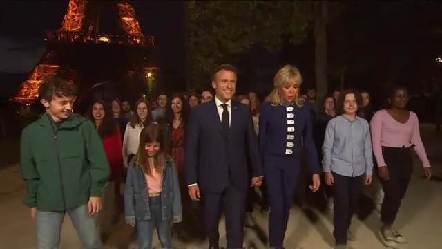 Macron and his wife walking with children