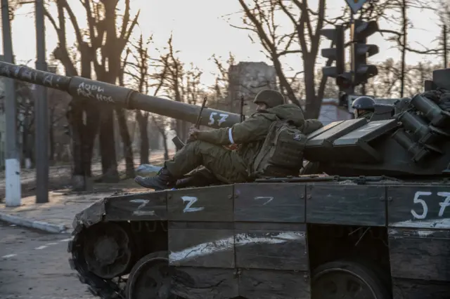 A Russian soldier sitting on top of a T-80 tank heading towards the Azovstal steel plant in Mariupol on 16 April