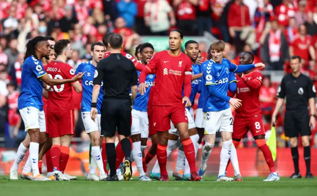 Everton and Liverpool players clash