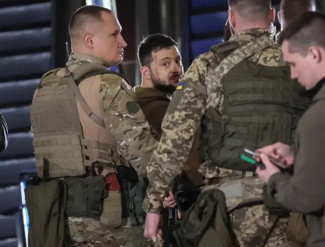 Flanked by soldiers, the Ukrainian leader leaves a press conference