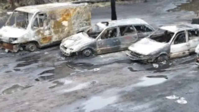 Wrecked cars at site of oil explosion