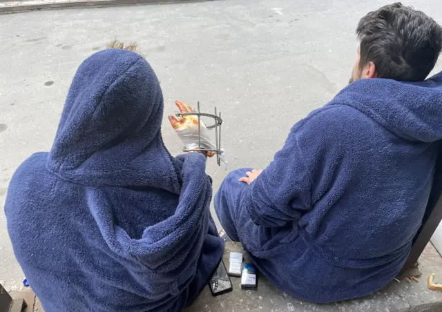 Two men sitting outside a hospital in Ukraine