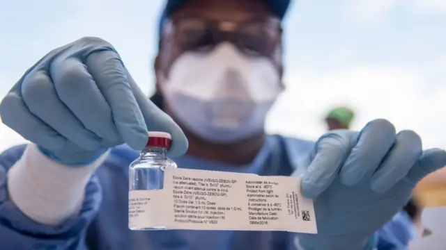 A nurse holds a bottle containing the Ebola vaccine in DR Congo - archive shot