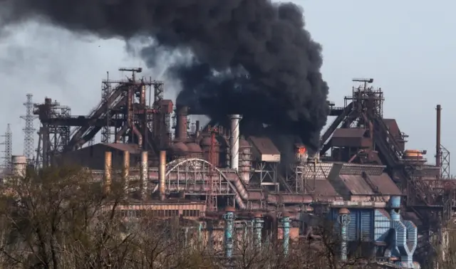 Smoke rises above a plant of Azovstal Iron and Steel Works  in the southern port city of Mariupol, on 25 April