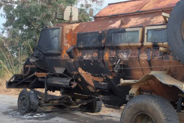 A photograph shows a burnt armoured personnel carrier (APC) in the port city of Mocimboa da Praia, northern Mozambique, on August 13, 2021