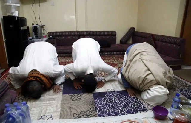 Addisu Gebeya family perform evening prayer after a fast-breaking (iftar) dinner in the first day of Muslim's holy month Ramadan inside their house as mosques and squares are closed due to the coronavirus (COVID-19) pandemic in Addis Ababa, Ethiopia, on April 24, 2020