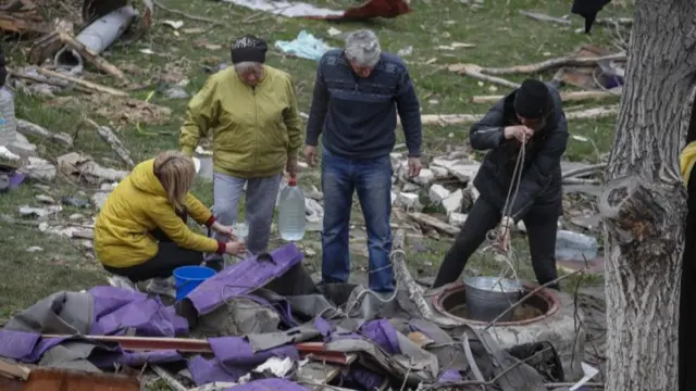 people get water from a well in downtown of Mariupol, Ukraine