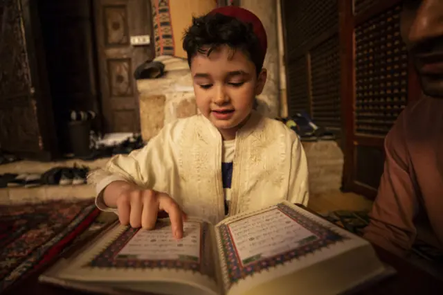 A boy at Sidi Okba Mosque during the Laylat al-Qadr, one of the Muslim's holiest nights, in Kairouan, Tunisia - 27 April 2022