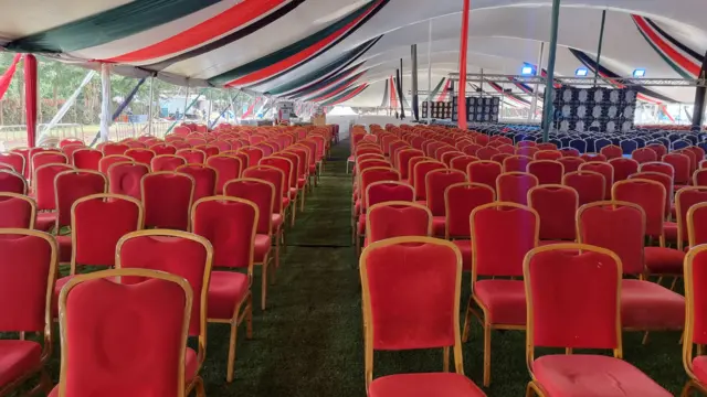 Red chairs in a tent at the Othaya Approved School