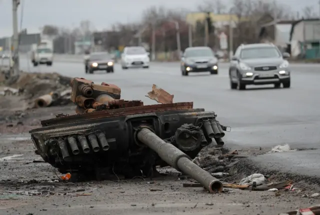 Part of a Russian tank lies by a road