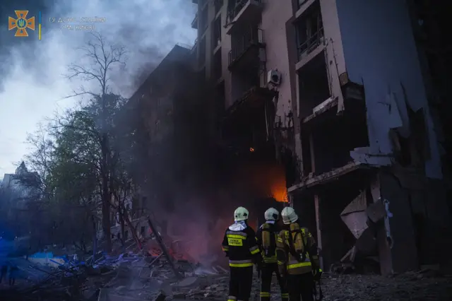 Rescuers work at a site of a residential building damaged by a Russian missile strike in Kyiv