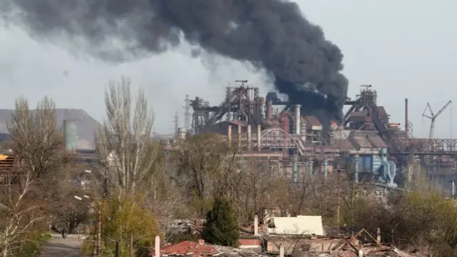 Smoke rises above a plant of Azovstal Iron and Steel Works in Mariupol