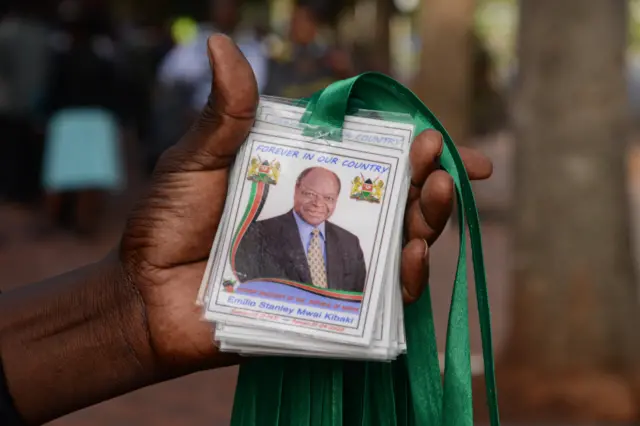 A vendor sells tags bearing the image of the late president Kibaki