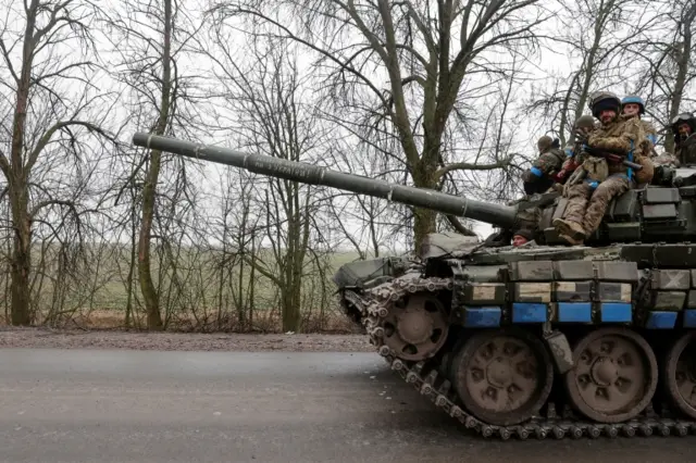 Ukrainian service members ride atop a tank, as Russia"s attack on Ukraine continues, in Chernihiv region on 2 April