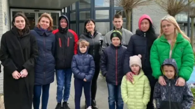 A picture of a Ukrainian family left stranded in the Netherlands after delays to their UK visas