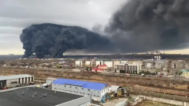 Image shows columns of smoke rising out of city