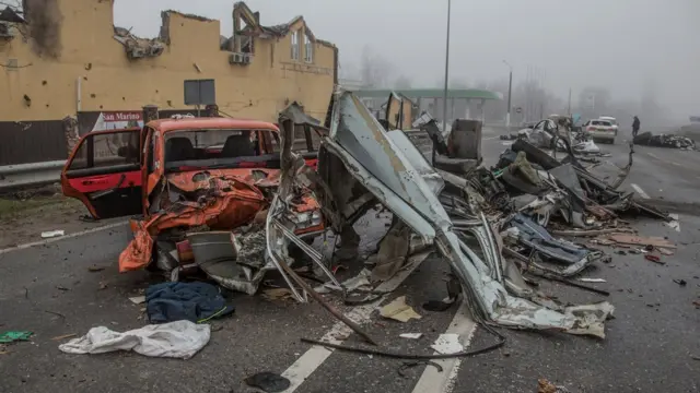 Squashed civilian cars are seen on a street in the town of Bucha