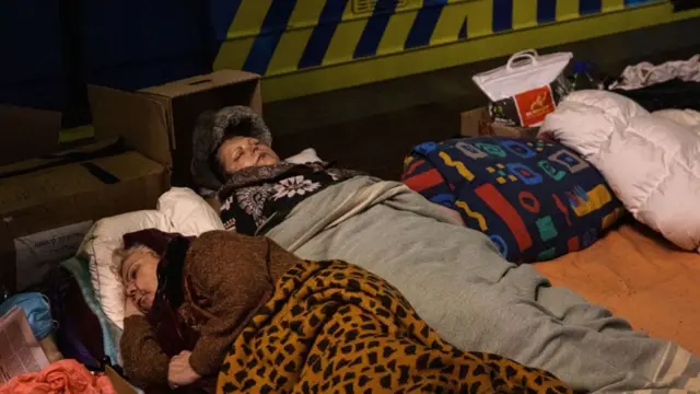 Women sleep as they take shelter in an underground metro station in Kharkiv, eastern Ukraine, on April 30 2022