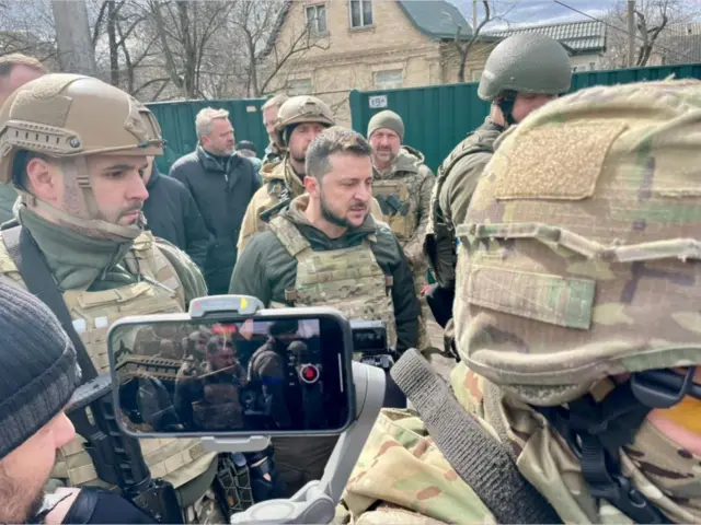 Ukrainian President Volodymyr Zelensky with troops in Bucha