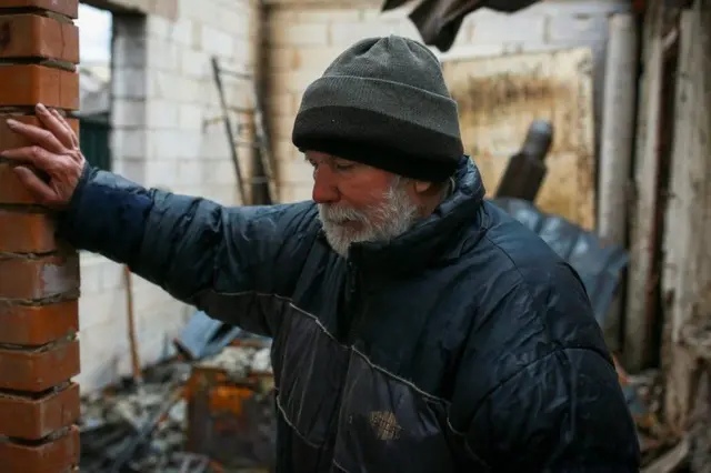 Volodymyr Abramov stands in the house once shared by his daughter and son-in-law.