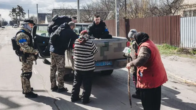 Bucha resident receive food aid on Monday