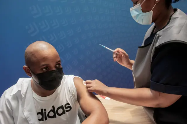 A man receives a dose of the Pfizer/BioNTech vaccine against COVID-19 at Discovery vaccination site in Sandton, Johannesburg,