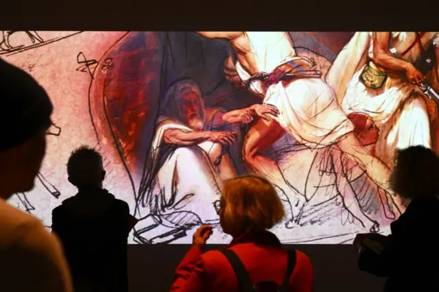 Visitors look at painting during the exhibition "Abdelkader, a figure of the Algerian independence" at the Mucem Museum in Marseille, southern France