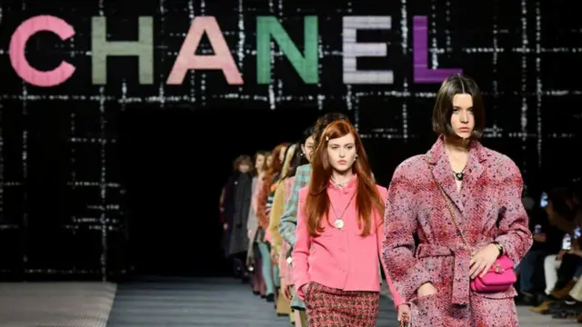 Models walk the runway at a Chanel fashion show in Paris