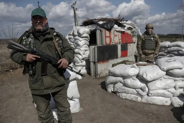 Ukrainian Territorial Defence forces at a checkpoint in the suburbs of Kharkiv city, 6 April