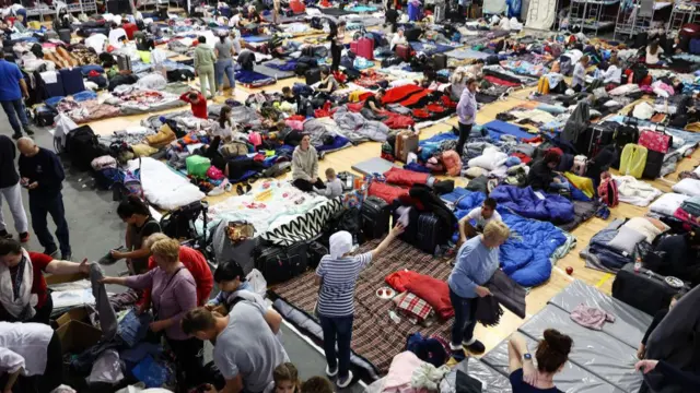 Ukrainians gather at the US-Mexico border as they await entry into America