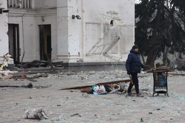 A man walks in Mariupol.