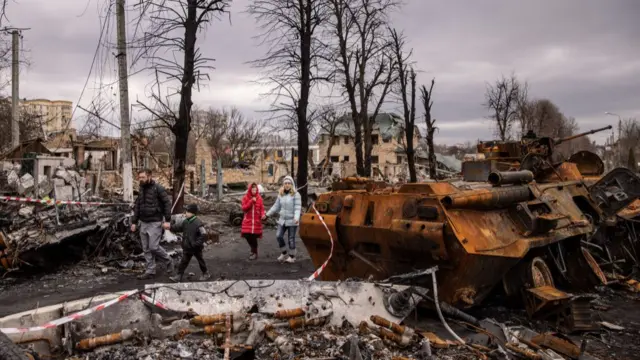 Residents walk through the streets of Bucha on Wednesday