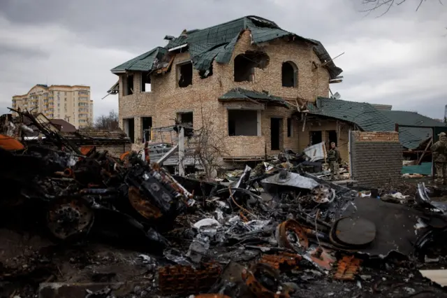 A destroyed house and debris in the Ukrainian city of Bucha