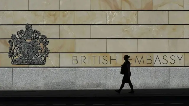 A woman walks past the UK embassy in Berlin