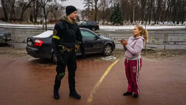 A fan greets Ukrainian rock star Andriy Khlyvnyuk as he serves in Kyiv's defence