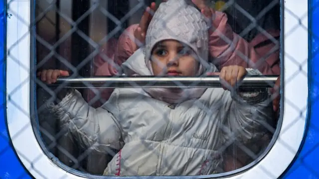 A child refugee arrives by train to Poland on Wednesday