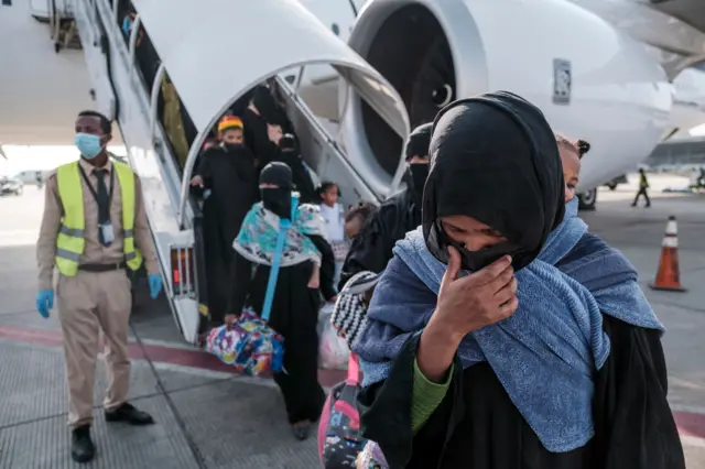 Ethiopian women disembark from the airplane at the Bole Airport,