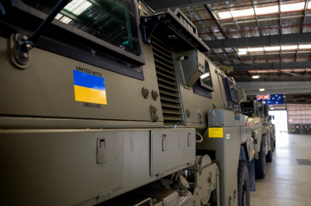 A Ukraine flag and 'United with Ukraine' message on one of the Australian 'Bushmaster' armoured vehicles