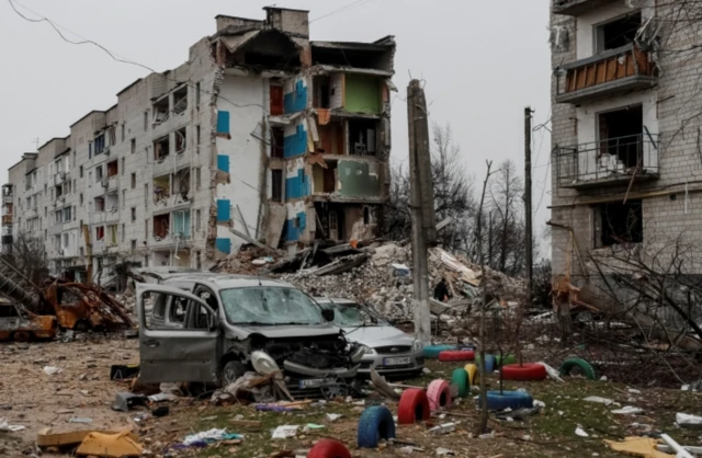 The shelled-out remains of cars and buildings in a Borodyanka street hit by Russia