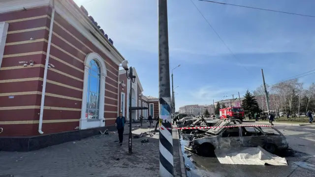 Image shows shelled out cars outside station